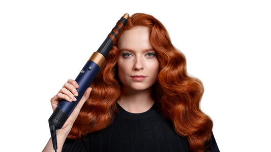 Front-on view of a woman curling her hair with the the Dyson Airwrap ID.
