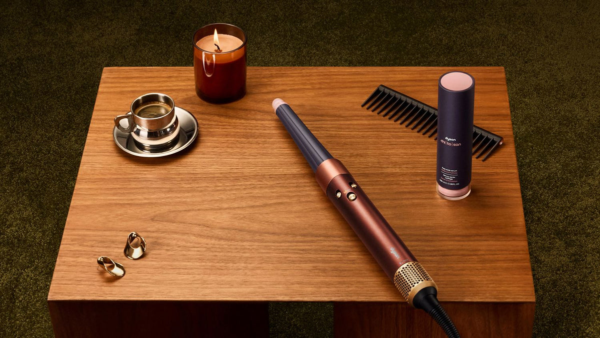 Dyson Airwrap i.d. multi-styler and dryer and Chitosan Post-style serum on a table.