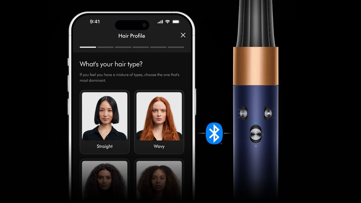 The Dyson Airwrap i.d. multi-styler and dryer next to a phone showing the MyDyson app.