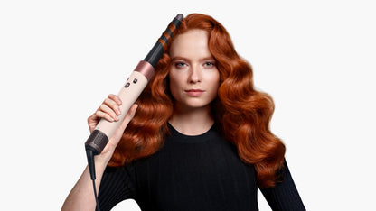 Front-on view of a woman curling her hair with the the Dyson Airwrap ID.