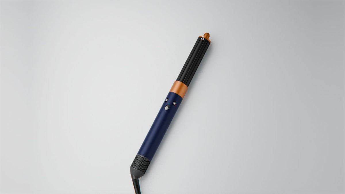 Dyson Airwrap Origin multi-styler and dryer on a surface.