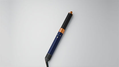 Dyson Airwrap Origin multi-styler and dryer on a surface.